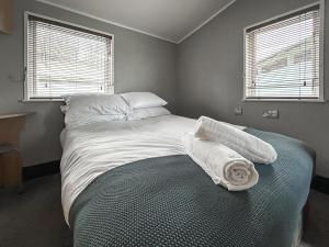 a bedroom with a bed with two towels on it at The Meadow - Uk51411 in Brechin