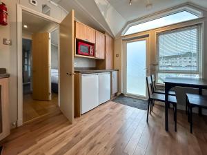 a kitchen and dining room with a table and a window at The Meadow - Uk51411 in Brechin