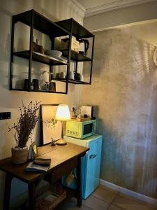 a kitchen with a wooden table and a microwave at Villa Basilicata in Pedale
