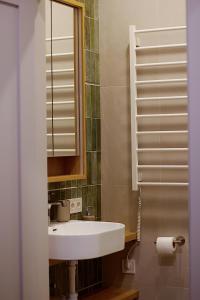 a bathroom with a sink and a mirror at Not A Hotel Cesis in Cēsis +20 photos