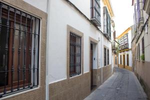 an empty alley in a city with buildings at La Casa de los Faroles in Córdoba