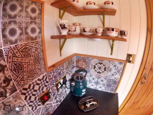 a room with a counter with plates and ceramics at Farmhouse in Swanage +164 photos