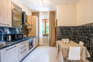 a kitchen with a table and a kitchen with a tableablish at Villa Panoramica in Perledo +16 photos