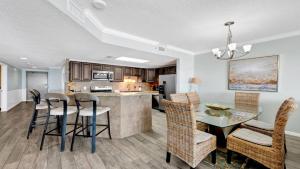 a kitchen and dining room with a table and chairs at Phoenix X 514 condo in Orange Beach