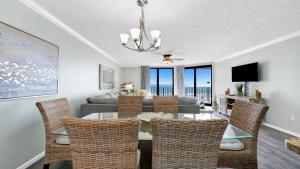 a dining room and living room with a table and chairs at Phoenix X 514 condo in Orange Beach +44 photos
