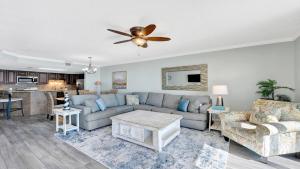 a living room with a couch and a ceiling fan at Phoenix X 514 condo in Orange Beach