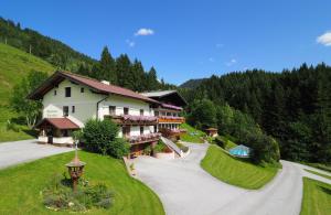 a large house on a hill with a driveway at Alpenapartments Unterschlag in Annaberg im Lammertal