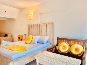 a bedroom with two beds with yellow pillows at Bstan Deluxe Beachfront in Diani Beach +53 photos