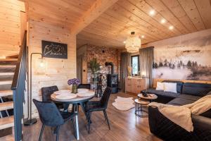 a living room with a couch and a table at Zacisze Anioła in Łobozew