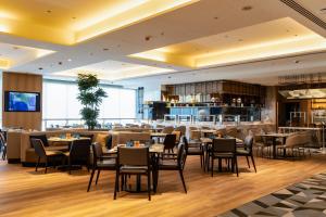 a restaurant with tables and chairs and a bar at Courtyard By Marriott Tirupati in Tirupati