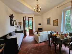a living room with a couch and a table at Villa Carla - vicino alla Riviera del Conero e ai Colli dell' Infinito in Ancona
