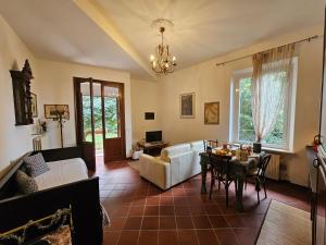 a living room with a couch and a table at Villa Carla - vicino alla Riviera del Conero e ai Colli dell' Infinito in Ancona