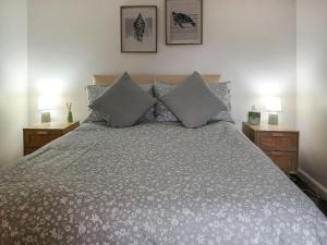a bedroom with a large bed with two night stands at Puffin Cottage in Fraserburgh