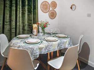 a dining room table with a black and white table cloth at Puffin Cottage in Fraserburgh