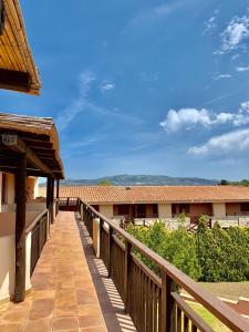 a wooden walkway leading to a building at Sporting Hotel in Cannigione