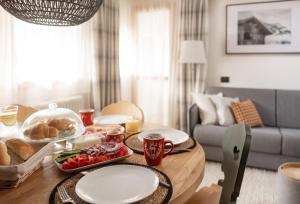 a wooden table with food on it in a living room at Casa Orso Elio - Si Mezzana Home in Mezzana