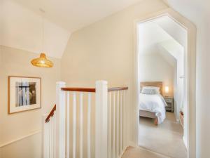 a hallway leading to a bedroom with a bed at The Mill Lodge in Malmesbury