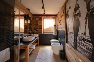 a bathroom with two sinks and two toilets at Casa Orso Elio - Si Mezzana Home in Mezzana