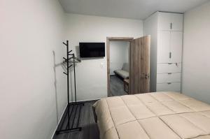 a bedroom with a bed and a television in it at Nára house 3 in Spata