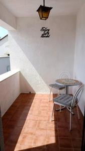 a table and chairs in a room with a staircase at Apartments Happy Day in Karlobag +16 photos