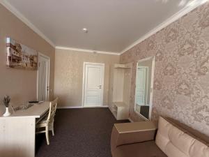 a living room with a couch and a table at Готель Лаванда in Khmelnytskyi +38 photos