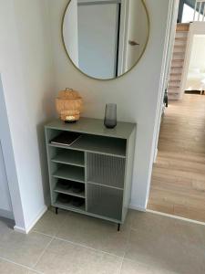 a green dresser in a hallway with a mirror at Modern House In Second Row At Rude Strand in Odder +20 photos