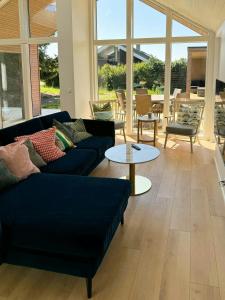 a living room with two couches and a table at Modern House In Second Row At Rude Strand in Odder