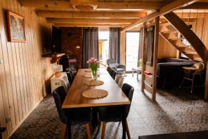 a dining room with a long wooden table and chairs at Talaria Resort&SPA in Trojanów