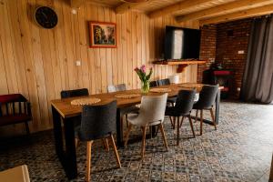 a dining room with a wooden table and chairs at Talaria Resort&SPA in Trojanów