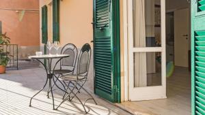 a patio with a table and chairs next to a door at Suite Alarcon - Goelba in Porto Azzurro