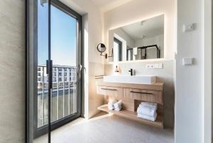 a bathroom with a sink and a large window at Yachthafen Barth - Ferienwohnung und Penthouses in Barth +61 photos