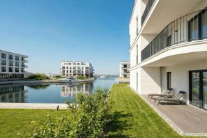 a building with a view of a river at Yachthafen Barth - Ferienwohnung und Penthouses in Barth