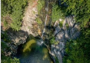 an aerial view of a waterfall over a river at Senderos del Mar, Hotel con AC, Piscina, cerca de Tayrona in Buritaca