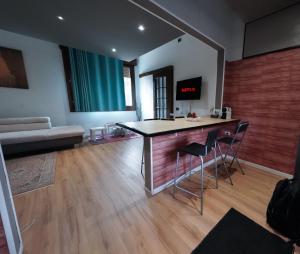 a living room with a table and chairs and a couch at The Ngatchou in Mestre