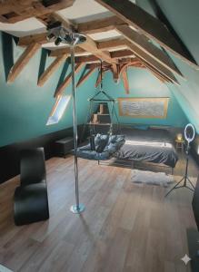 a room with a bed in a room with wooden floors at Romantic love room house in Aix