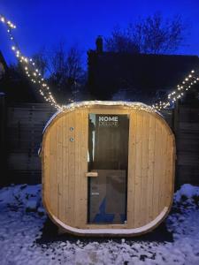 a round wooden building with lights in the snow at Romantic love room house in Aix