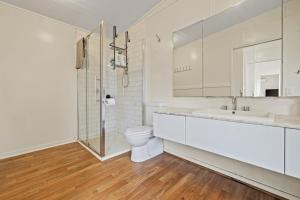 a white bathroom with a toilet and a sink at Tiny house at Gilderoy Valley Views in Yarra Junction +37 photos