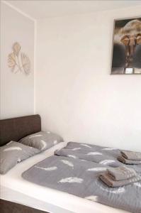 a bed in a room with a picture on the wall at Apartments Happy Day in Karlobag