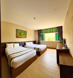 a hotel room with two beds and a window at My Marina Beach Hotel Phu Quoc in Phú Quốc +101 photos