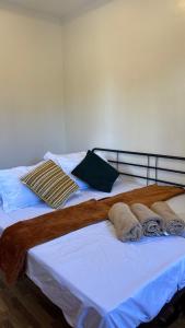 a bed with towels and pillows on it at R&G Residences in Legazpi