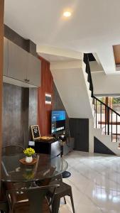 a dining room with a table with a laptop on it at R&G Residences in Legazpi