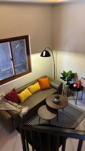 a living room with a couch and a table at R&G Residences in Legazpi