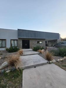 a stone house with a driveway in front of it at Elysium de Uco in Tupungato