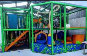 a green cage with a play area with toys at Three Lochs Holiday Park, 139 Loch View with Lazy Spa Hot Tub, Platinum 3 bedroom Holiday Home for Hire in Balminnoch