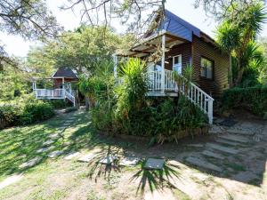 a house with a porch and stairs leading to it at A Stone's Throw in Grahamstown