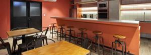 a bar with wooden tables and stools in a kitchen at Modern loft with panoramic views in Monterrey +16 photos