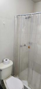 a bathroom with a white toilet and a shower at Hotel Distrito Unicentro in Medellín