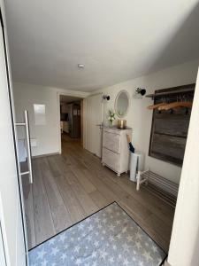 an empty living room with a vanity and a mirror at Ferienhaus Tafolli in Linsengericht +4 photos
