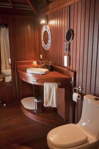 a bathroom with a sink and a toilet at Robinson's Cove Villas in Papetoai