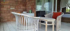 a table and two chairs on a patio at Rumah Putih Beachfront Bungalow in Tegallengah